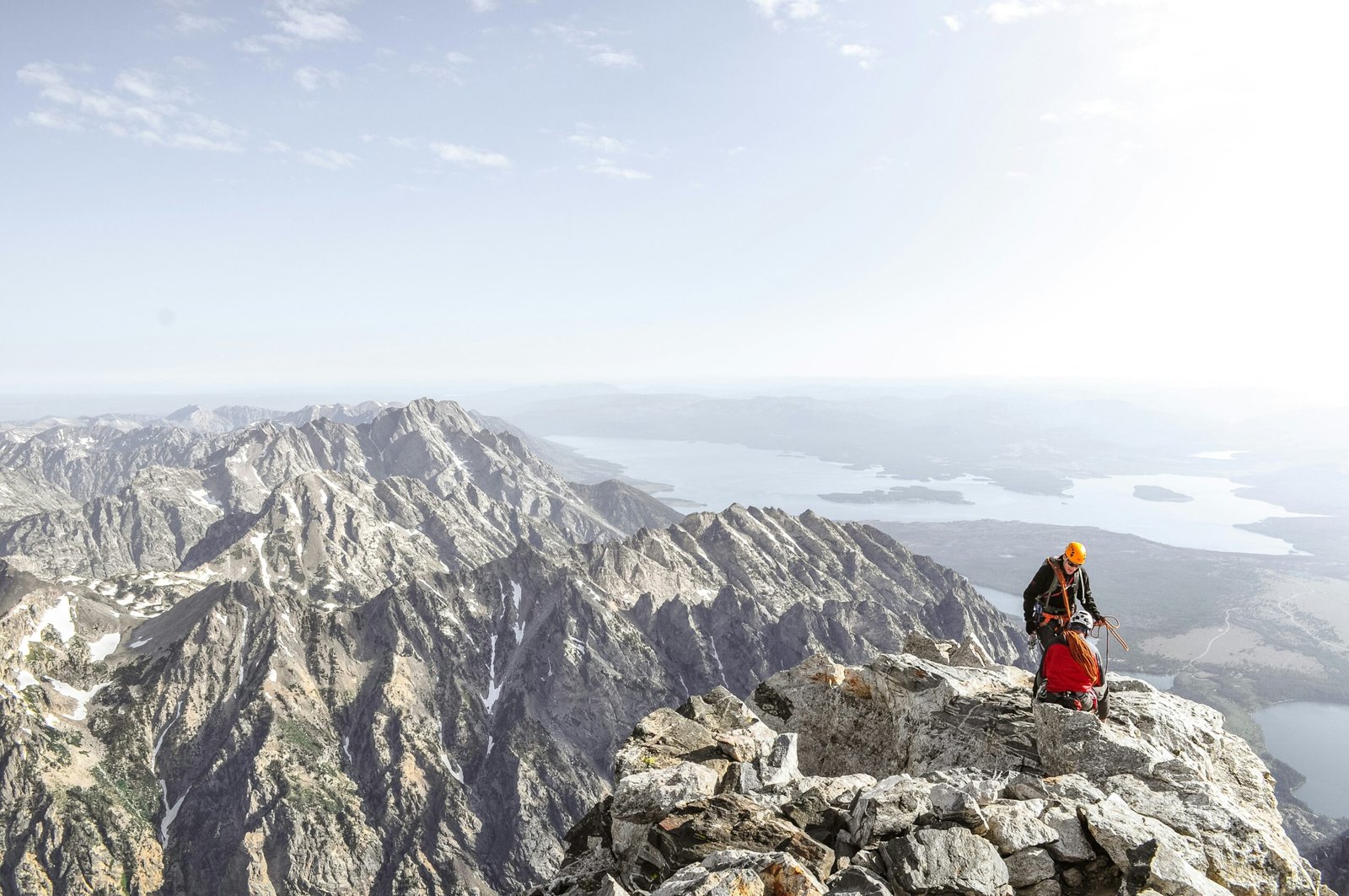 photo of man on top of mountain during daytime